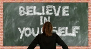 What is hypnotherapy used for? Improving self-esteem. A blackboard with text saying believe in yourself.