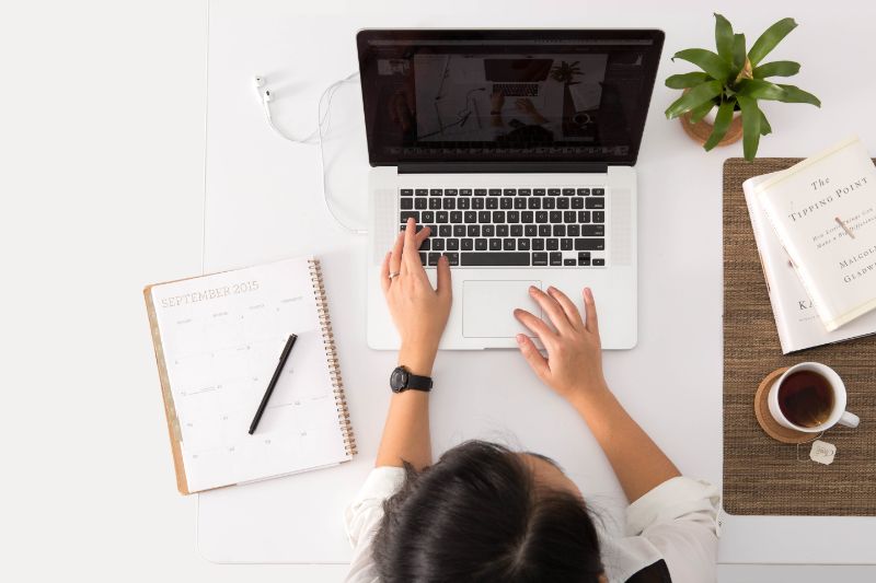 New career - a hypnotherapist working online at her laptop