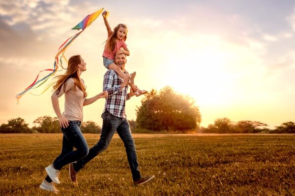 family happy field children couple sky sunset hypnosis tips for back to school term time holidays