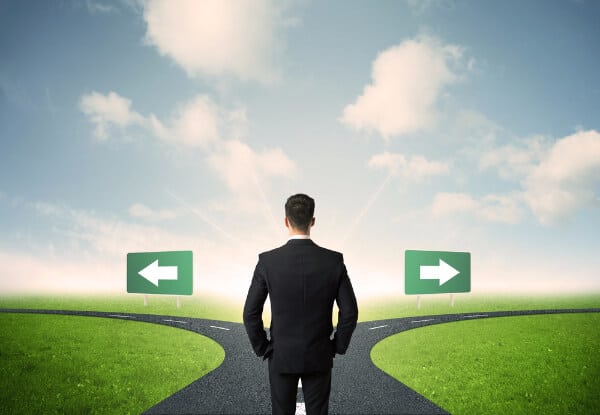 Resilience means that you can make decisions. Image of a man at  a junction choosing left or right
