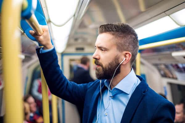 man tube london commute travel music ipod sounds headphones commute to work hypnotherapist hypnotherapy wellbeing at work