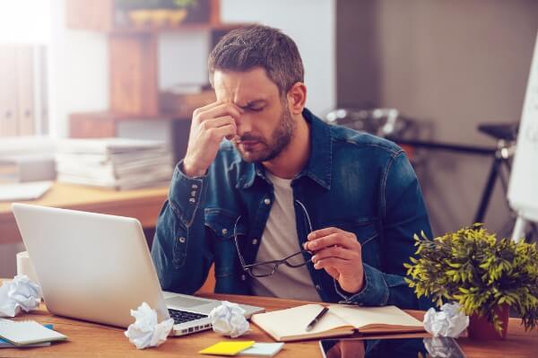 time optimisation - overwhelmed too much cope stress anxiety overwhelming man office computer laptop headache man hypnotherapy optimise time management