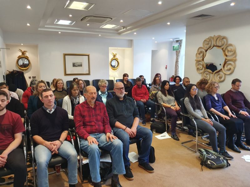 Analytical hypnotherapy - a class of people sitting in chairs with their eyes closed.